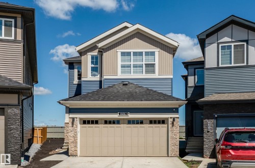 Contemporary two-story residence featuring a two-tone blue and beige siding exterior - 8426 228A Street Nw, Edmonton, AB - Outdoor