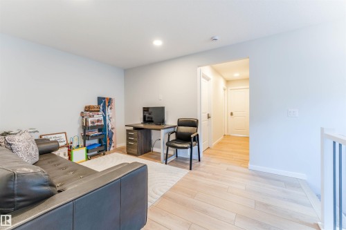 Versatile room featuring light-toned wood-finish flooring and recessed lighting - 8426 228A Street Nw, Edmonton, AB - Indoor