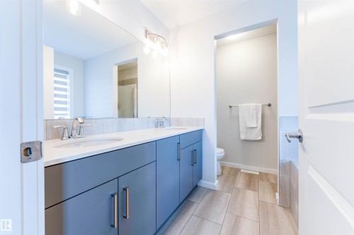 Dual vanity featuring undermount sinks, chrome fixtures, and a white countertop - 8426 228A Street Nw, Edmonton, AB - Indoor Photo Showing Bathroom