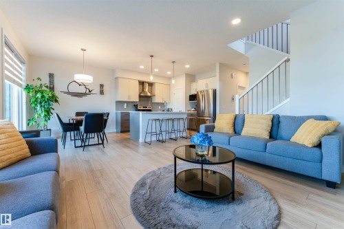 Bright living space featuring wood-finish flooring throughout - 8426 228A Street Nw, Edmonton, AB - Indoor Photo Showing Living Room