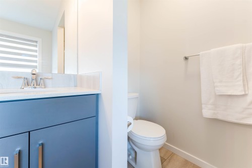 Bathroom vanity with a light blue cabinet and quartz countertop - 8426 228A Street Nw, Edmonton, AB - Indoor Photo Showing Bathroom