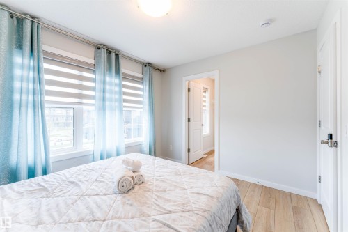 Room featuring abundant natural light, wood-finish flooring, and light-toned walls - 8426 228A Street Nw, Edmonton, AB - Indoor Photo Showing Bedroom