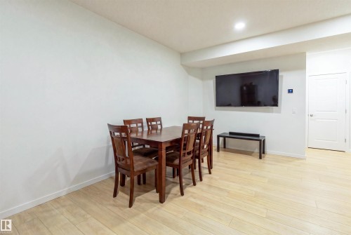 Spacious room featuring light wood-finish flooring, recessed lighting, and a neutral white wall color - 8426 228A Street Nw, Edmonton, AB - Indoor Photo Showing Other Room