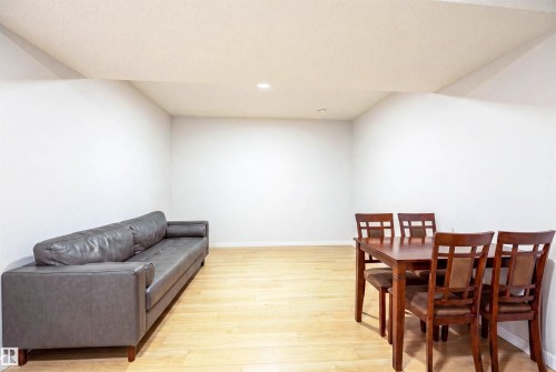 Spacious room featuring light wood-finish flooring, recessed lighting, and crisp white walls - 8426 228A Street Nw, Edmonton, AB - Indoor