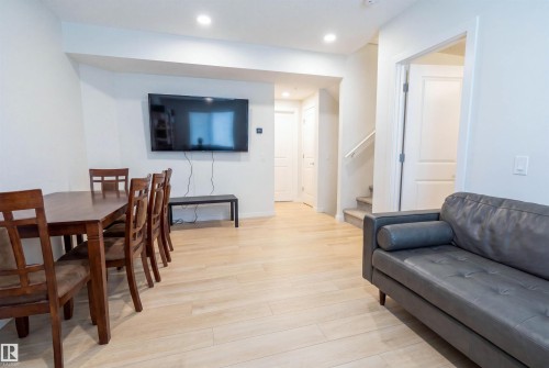 Open-concept living area with recessed lighting and light wood-finish flooring - 8426 228A Street Nw, Edmonton, AB - Indoor