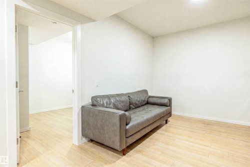 Light wood-finish flooring throughout, complemented by crisp white walls and ceiling - 8426 228A Street Nw, Edmonton, AB - Indoor
