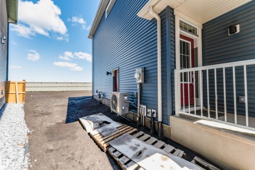 Navy blue siding with white trim and a vibrant red entry door - 8426 228A Street Nw, Edmonton, AB - Outdoor