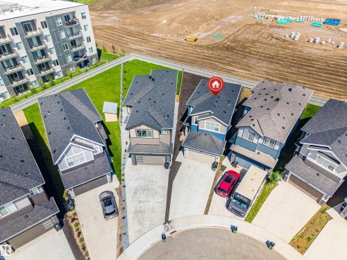 Modern two-story residence featuring a dark shingle roof, light blue siding, white trim, and an attached garage - 8426 228A Street Nw, Edmonton, AB - Outdoor