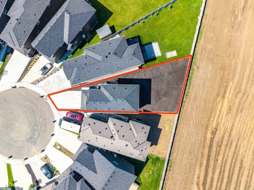 Aerial perspective of a property featuring a dark-toned roof, a paved driveway, and a concrete perimeter - 8426 228A Street Nw, Edmonton, AB -  With View