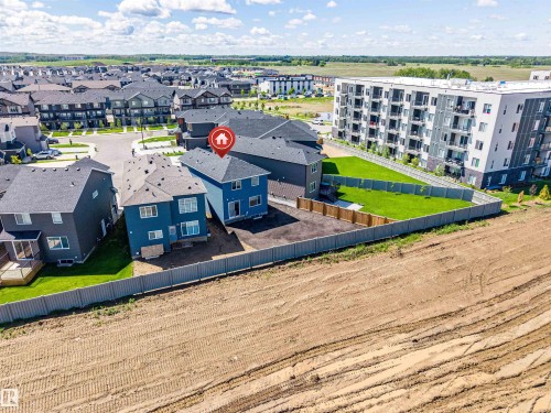 Two-story residential property with dark blue siding and a dark shingle roof - 8426 228A Street Nw, Edmonton, AB - Outdoor With View