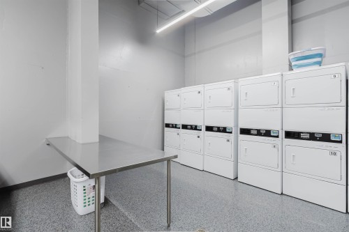On-site laundry facility featuring multiple stackable washer/dryer units - 904 10883 Saskatchewan Drive, Edmonton, AB 