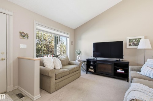 Living area with neutral wall tones and carpeted flooring - 11715 11B Avenue, Edmonton, AB 