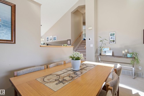 Dining area featuring a wood-finish table with tiled inlay - 11715 11B Avenue, Edmonton, AB 