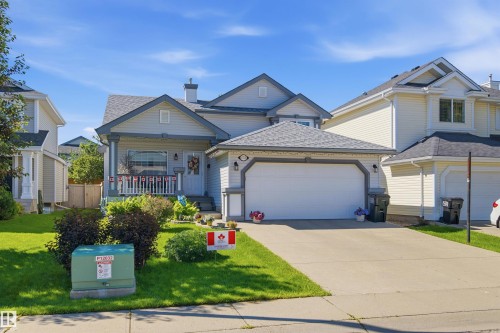 Light gray siding exterior with dark gray trim and roof - 11715 11B Avenue, Edmonton, AB 