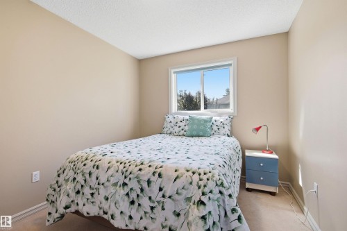 Bedroom featuring neutral-toned walls, white ceiling, and carpeted flooring - 11715 11B Avenue, Edmonton, AB 