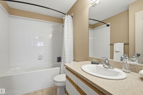 Full bathroom featuring a white tub-shower combination with subway tile surround - 11715 11B Avenue, Edmonton, AB 