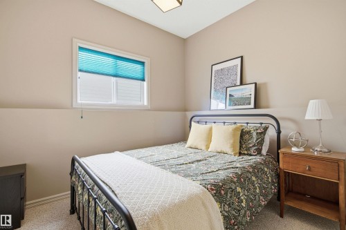 Neutral-toned walls and a vaulted ceiling define this bedroom space - 11715 11B Avenue, Edmonton, AB 