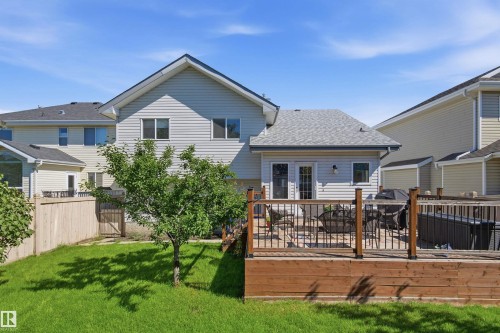 Expansive wood-finish deck with dark metal railings - 11715 11B Avenue, Edmonton, AB 
