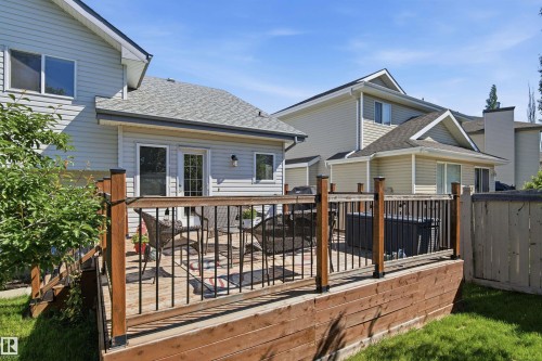 Tiered wood deck featuring black metal balusters and a privacy fence - 11715 11B Avenue, Edmonton, AB 