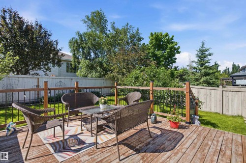 Spacious wood-finish deck with a wood and metal railing - 11715 11B Avenue, Edmonton, AB 