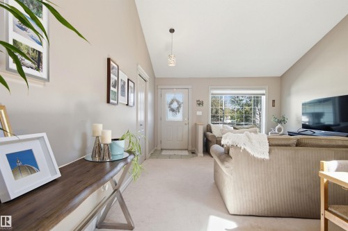 Vaulted ceiling living space with light-colored walls and carpet flooring - 11715 11B Avenue, Edmonton, AB 