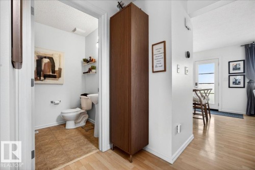 Compact powder room featuring a pedestal sink, toilet, and tile flooring - 3934 160 Avenue, Edmonton, AB 