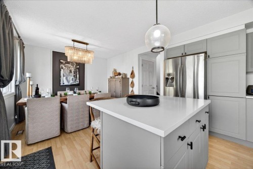 Open-concept living space with light wood-finish flooring - 3934 160 Avenue, Edmonton, AB 