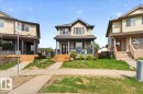 Two-story residential property featuring a covered front porch with railings - 3934 160 Avenue, Edmonton, AB 