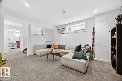 Spacious living area featuring neutral carpet flooring and recessed ceiling lighting - 3934 160 Avenue, Edmonton, AB 