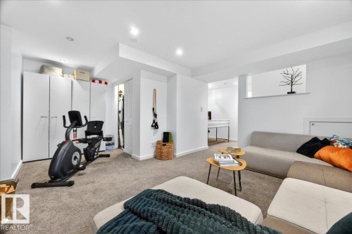 Spacious room featuring neutral carpeting, recessed lighting, white walls, and built-in white cabinetry providing extensive storage - 3934 160 Avenue, Edmonton, AB 