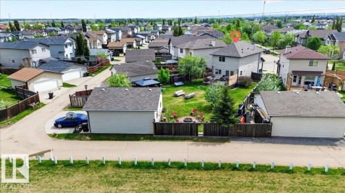 Two-story residence with a gray exterior, dark shingle roof, and a visible backyard space - 3934 160 Avenue, Edmonton, AB 