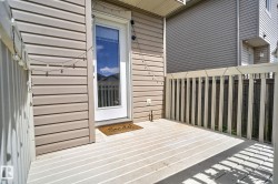 Expansive outdoor deck featuring wood-finish flooring and a white railing - 