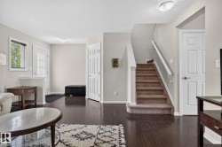 Staircase featuring carpeted treads and a painted railing system - 