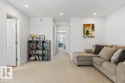 Spacious carpeted hallway with recessed lighting and neutral wall finishes - 