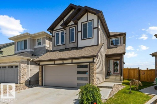 Modern two-story residence featuring a combination of siding and stone veneer accents - 25 Nettle Crescent, St. Albert, AB 