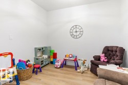 Neutral white walls and wood-finish flooring provide a versatile foundation for this room - 