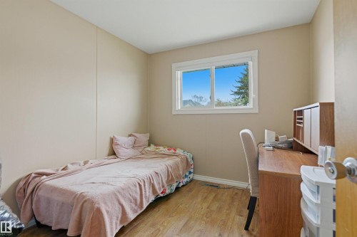 Room with wood-finish flooring, a double-paned window, and neutral wall tones - 8911 169 Street Nw, Edmonton, AB 