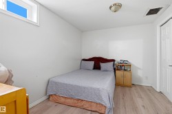 Room with light wood-finish flooring and white baseboards - 