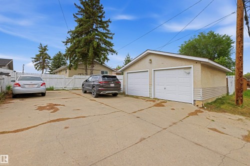 Detached two-car garage with white panel doors and stucco exterior - 8911 169 Street Nw, Edmonton, AB 