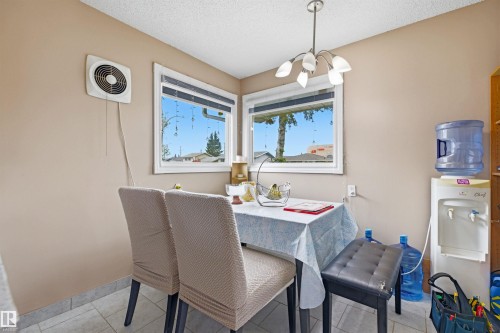 Dining area featuring tiled flooring, neutral wall paint, and a contemporary ceiling light fixture - 8911 169 Street Nw, Edmonton, AB 