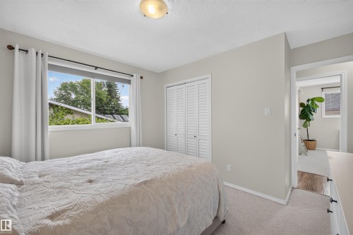 Bright room with light-toned walls and neutral carpeting - 244 Knottwood Road N, Edmonton, AB 