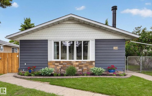 Charming home featuring horizontal siding, decorative shingles, and a natural stone accent facade - 244 Knottwood Road N, Edmonton, AB 
