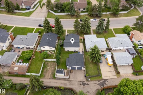 Single-family residence featuring a dark shingle roof and light-colored siding - 244 Knottwood Road N, Edmonton, AB 