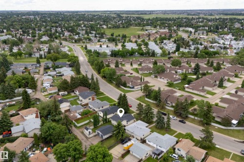 Aerial perspective showcasing a residential neighborhood with established homes and mature trees - 244 Knottwood Road N, Edmonton, AB 