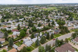 Aerial perspective showcasing a residential neighborhood with established homes and mature trees - 