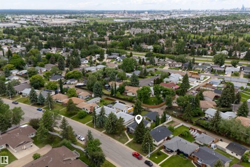 Aerial perspective showcasing a residential area with mature trees and a structured street layout - 244 Knottwood Road N, Edmonton, AB 