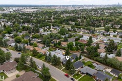 Aerial perspective showcasing a residential area with mature trees and a structured street layout - 