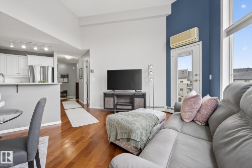 Open-concept living area with high ceilings and wood-finish flooring - 421 9730 174 Street, Edmonton, AB 