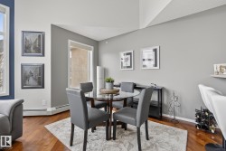 Dining area featuring wood-finish flooring and a large window - 