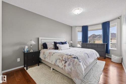 Hardwood-finish flooring extending into the bay window area - 421 9730 174 Street, Edmonton, AB 